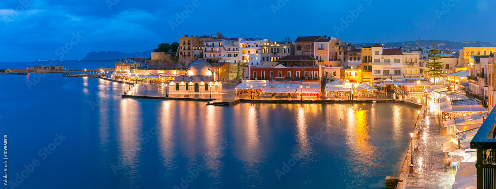 Picturesque panoramic view of Venetian quay of Chania with Kucuk Hasan Pasha Mosque during twilight blue hour, Crete, Greece