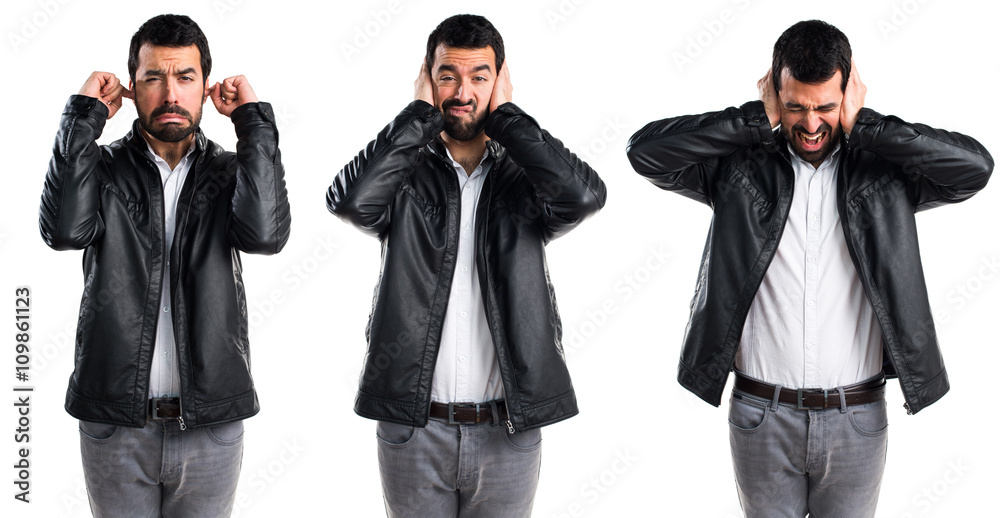 Man with leather jacket covering his ears Man with leather jacket covering his ears