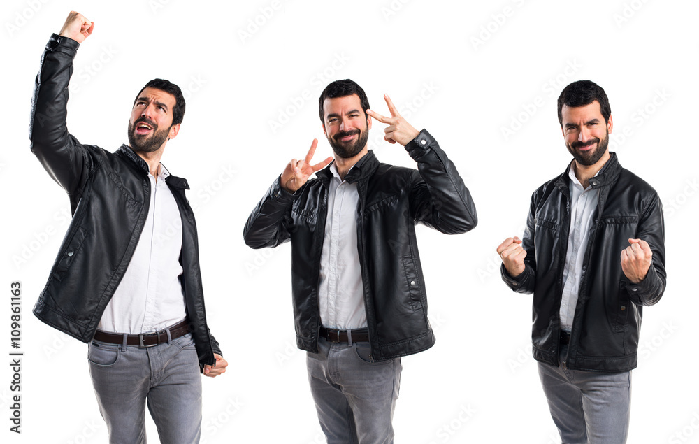 Man with leather jacket doing victory gesture Man with leather jacket doing victory gesture