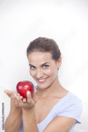 Beautiful woman with red apple in hand