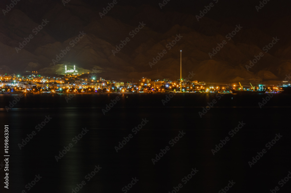 Aqabah, the Jordanian seaport city at night, as seen from the neighbouring city Eilat of Israel.