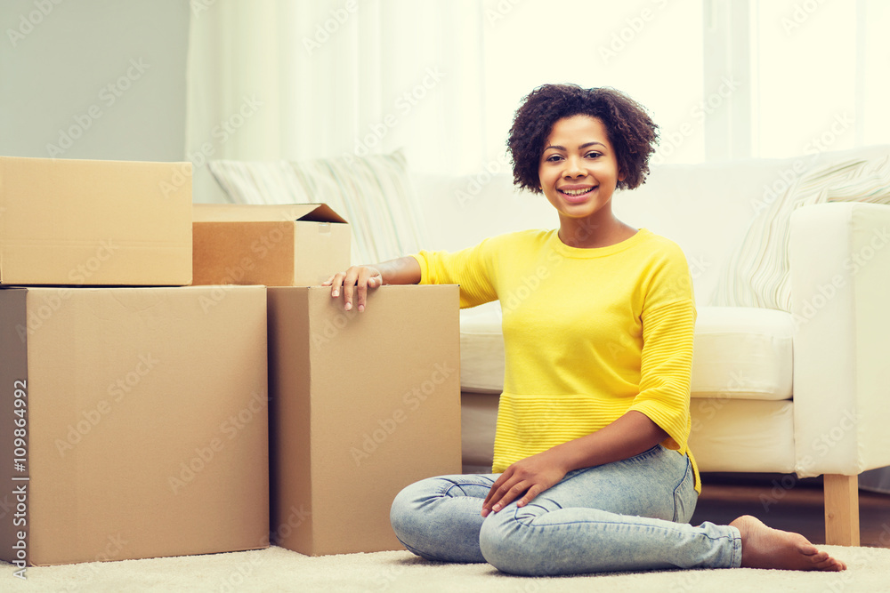 happy african woman with cardboard boxes at home happy african woman with cardboard boxes at home