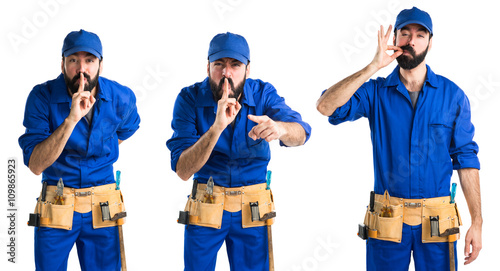 Plumber making silence gesture