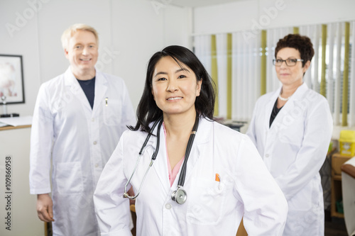 Confident Female Doctor Smiling While Standing With Colleagues