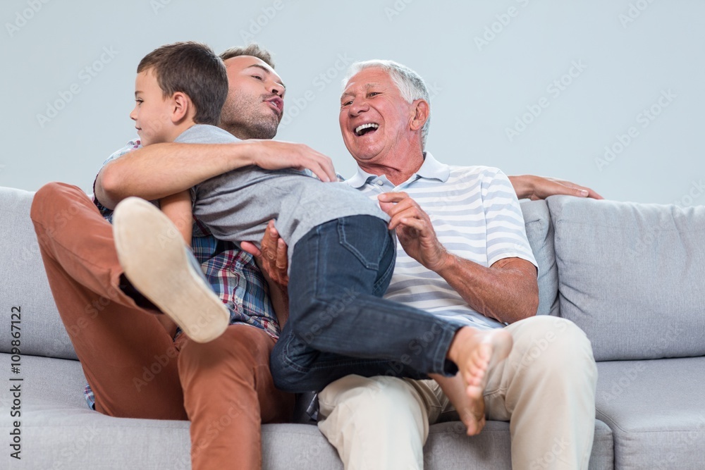 Son embracing father in living room