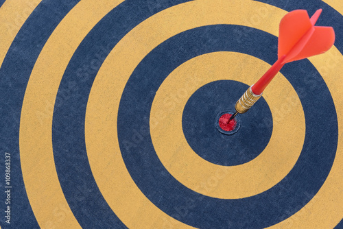 Dart target with arrow on bullseye, Goal target success business investment financial strategy concept, abstract background