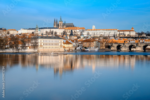 Charles Bridge, St. Vitus Cathedral and other historical buildings in Prague reflected in the river. This image is toned.