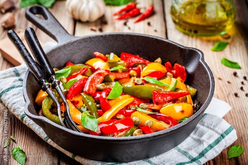 Italian cuisine, peperonata: roasted bell pepper with capers and basil photo