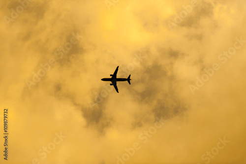 airplane flying in the blue sky with clouds