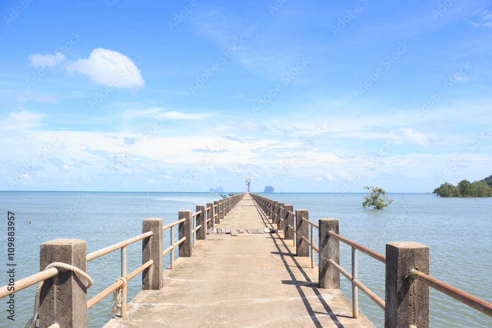 old wooden and concrete bridge to dock pier in tranquil sea to find destination way,Trang Thailand