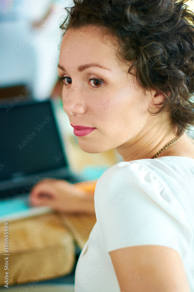 Candid image of succesful business woman caught in an animated brainstorming meeting Candid image of succesful business woman caught in an animated brainstorming meeting