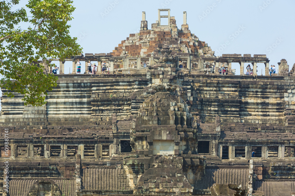 Baphuon Temple  with clear blue sky and tourists, Cambodia