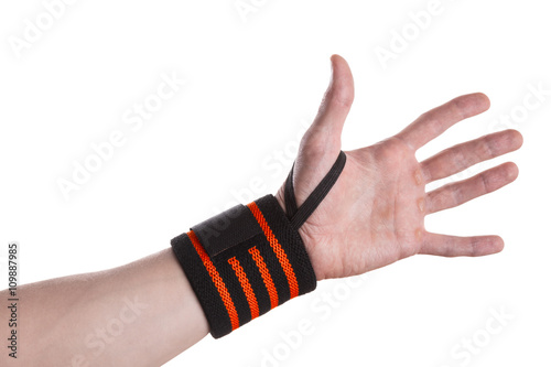 Calloused hand of a weightlifter with black and orange wrist wrap isolated on white background