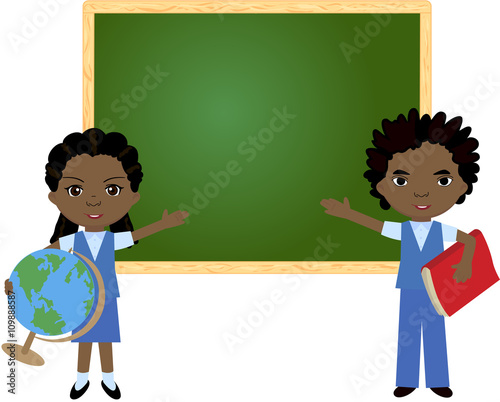 African boy and girl standing near the blackboard in a classroom