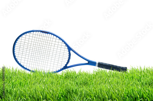 Blue tennis racket on green grass isolated white background