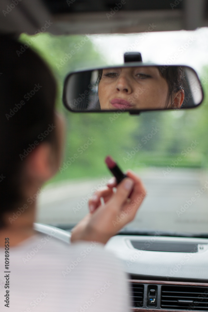 applying lipstick while driving a car