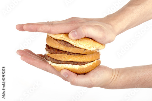 a hand pressing the hamburger