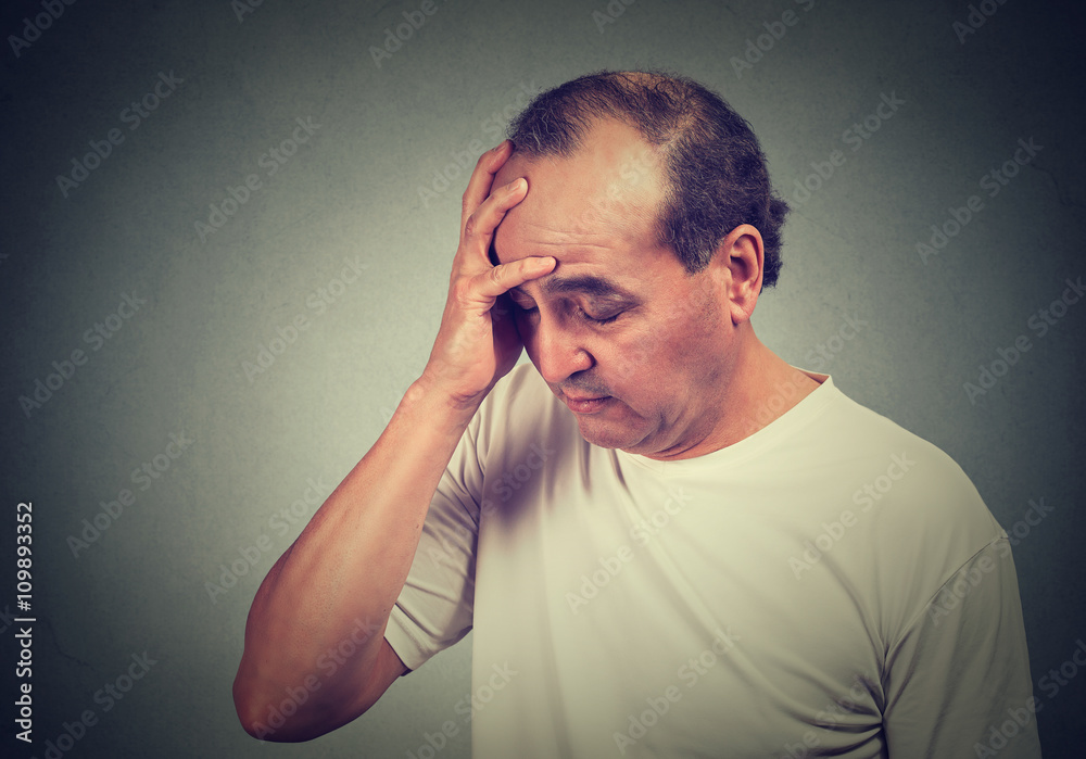 portrait of middle aged desperate man isolated on gray wall background portrait of middle aged desperate man isolated on gray wall background