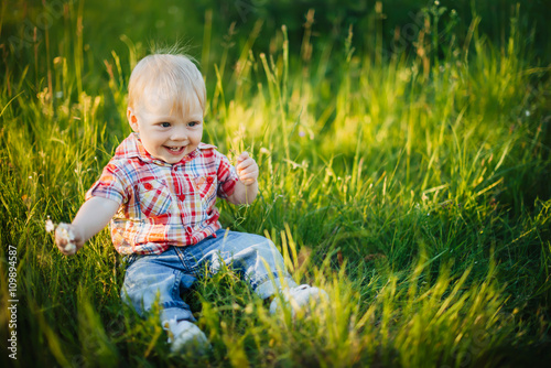 child sitting on the grass