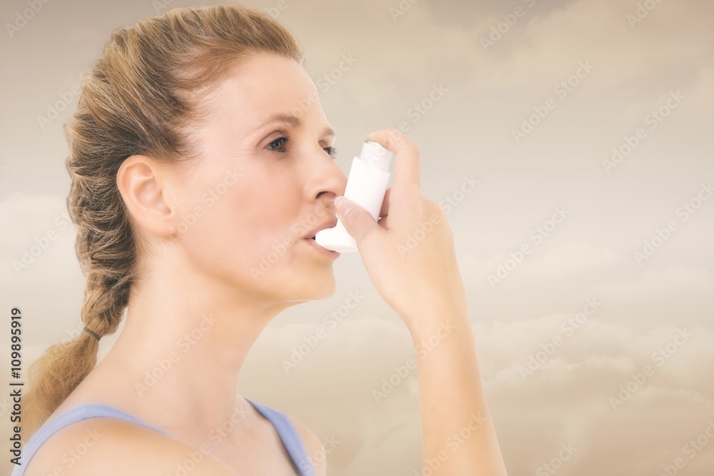 Composite image of woman using inhaler for asthma Composite image of woman using inhaler for asthma