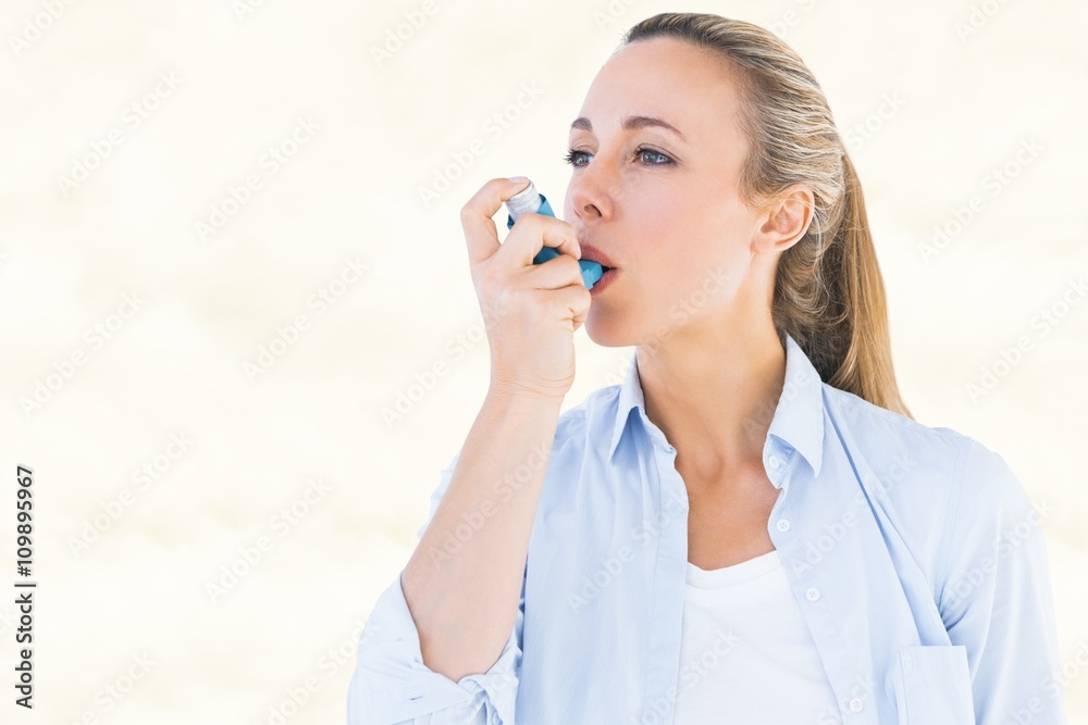 Composite image of pretty blonde using an asthma inhaler Composite image of pretty blonde using an asthma inhaler