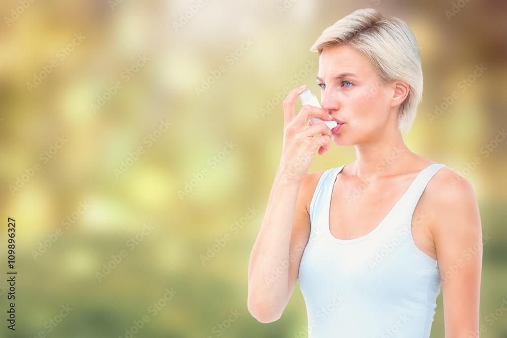 Composite image of blonde woman taking her inhaler Composite image of blonde woman taking her inhaler