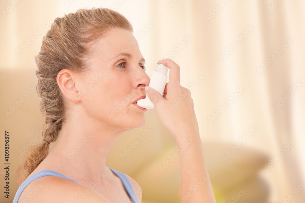 Composite image of woman using inhaler for asthma Composite image of woman using inhaler for asthma