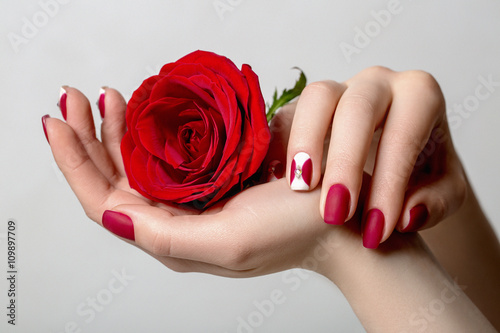Beautiful woman's nails with interesting red manicure