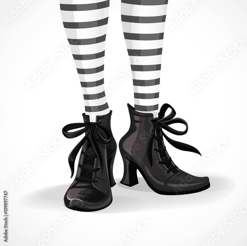 Halloween closeup witch legs in striped stockings and black boot