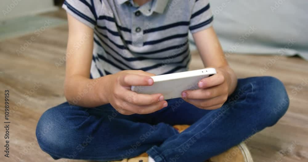 A boy playing games on smartphone