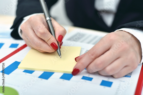 woman taking notes on paper