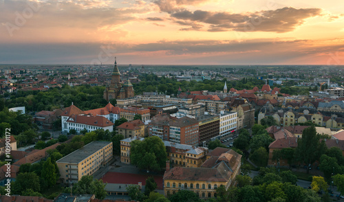 European city skyline seen by a professional drone at sunset and cloudy sky
