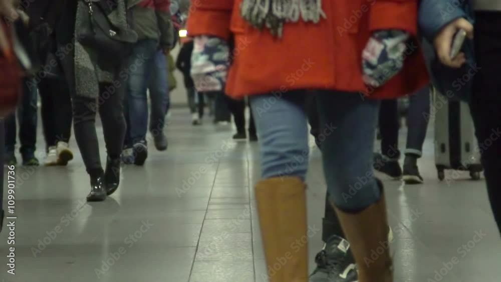 Young people walking in long corridor at airport terminal or railway station Young people walking in long corridor at airport terminal or railway station
