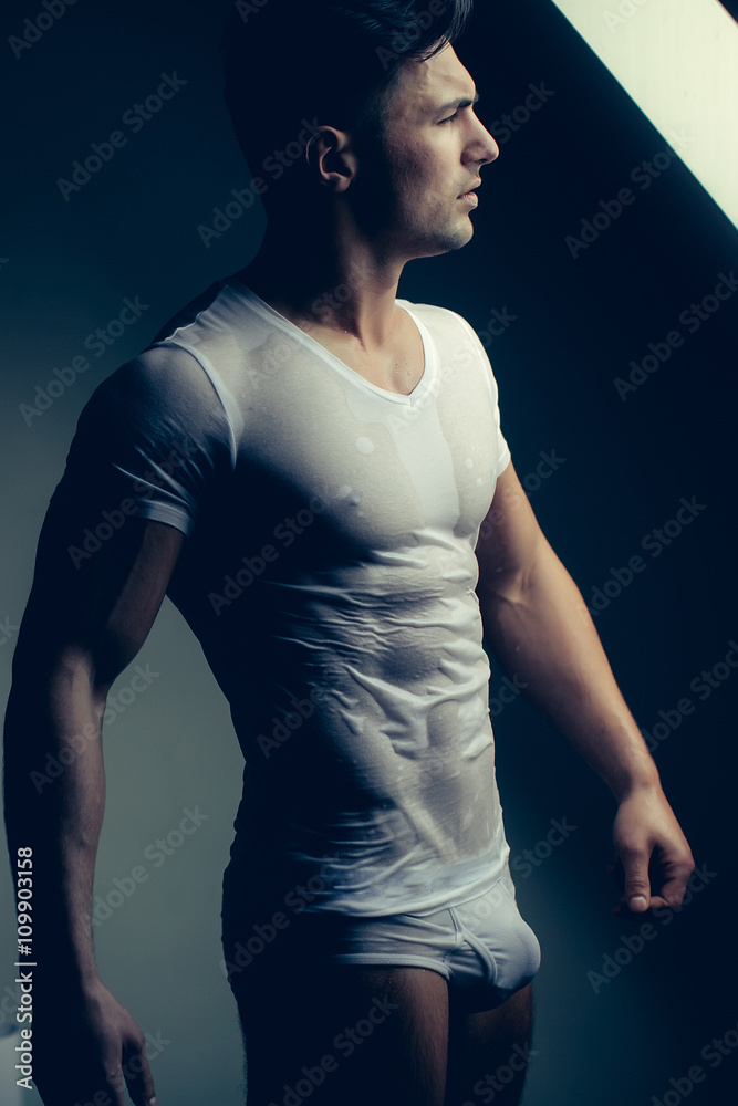 Muscular man in wet shirt Stock Photo | Adobe Stock