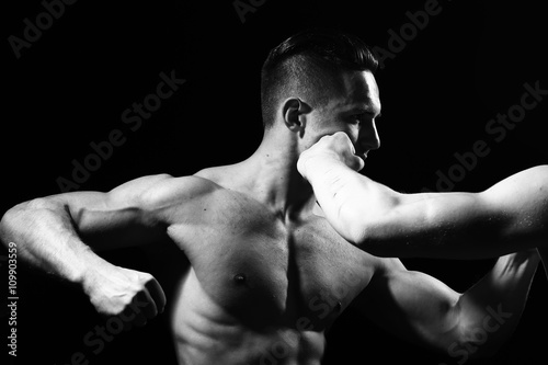 Young muscular men boxing
