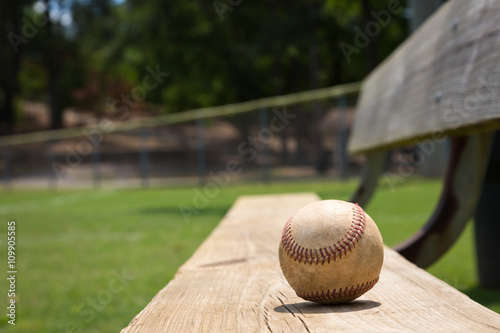 Photography Baseball on a bench in a little league field