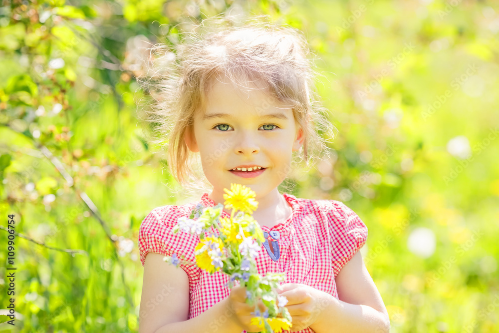 Happy little girl playing with bouquet in sunny park Happy little girl playing with bouquet in sunny park