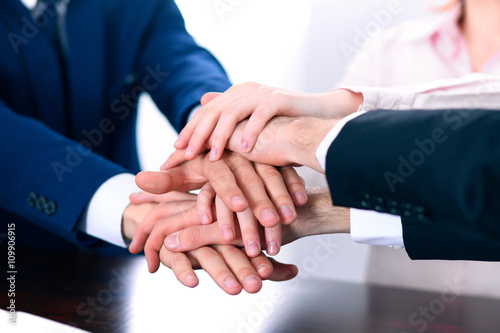 Business people group joining hands and representing concept of friendship and teamwork