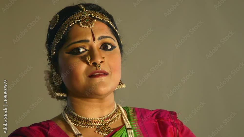 The dramatic makeup of a classical Indian dance performer accentuates the emotional expressions she uses during her traditional dance moves.