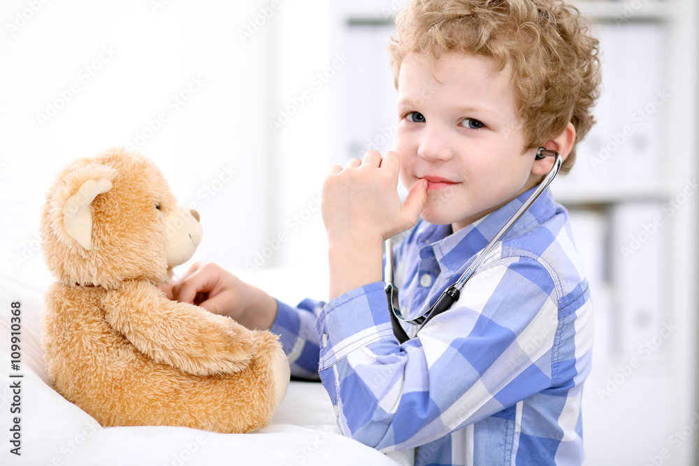 Doctor examining a child patient by stethoscope Doctor examining a child patient by stethoscope