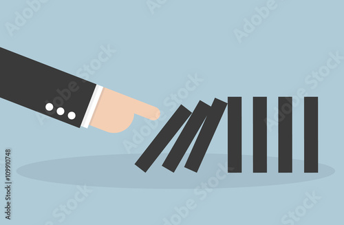 Businessman hand pushing the domino effect