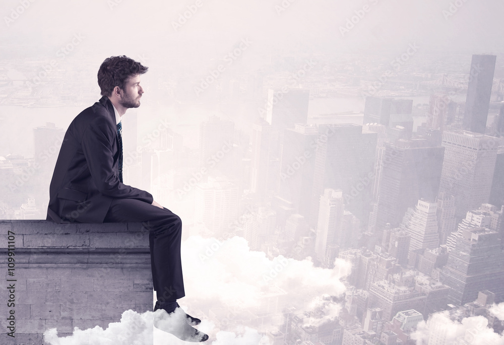 Sales person sitting on building edge in city Sales person sitting on building edge in city