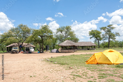 Safari campsite  camp-lodge  in savanna against blue sky background. Serengeti National Park  Great Rift Valley  Tanzania  Africa.   