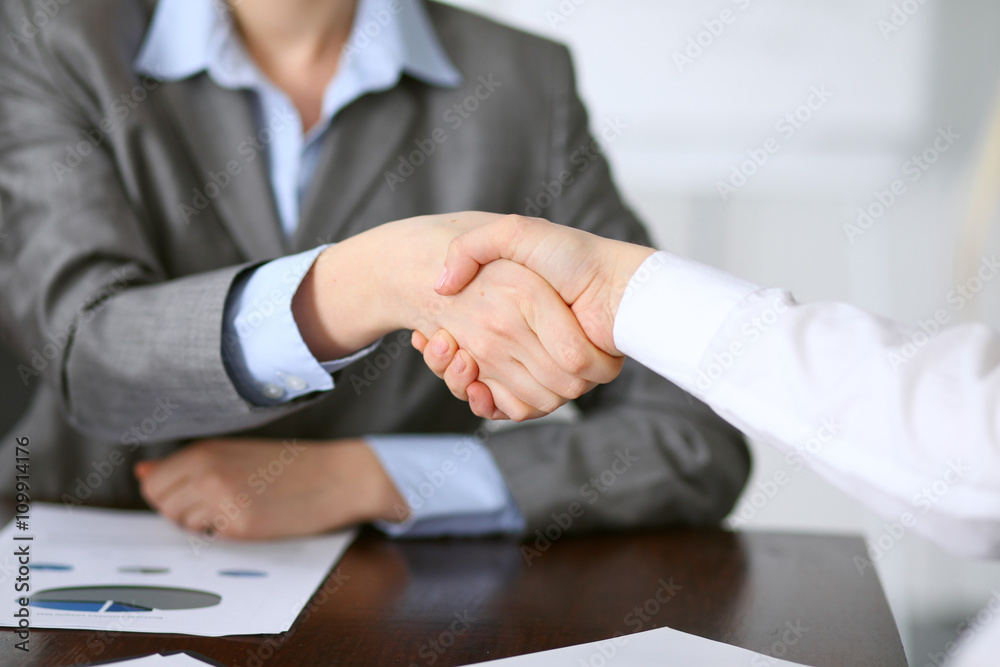 Close up  of unknown  business people handshake
