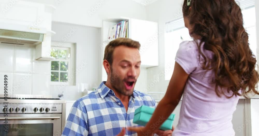 Cute daughter giving a present to her father Cute daughter giving a present to her father