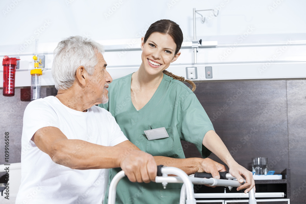 Nurse Assisting Senior Man To Use Walker At Rehab Center Nurse Assisting Senior Man To Use Walker At Rehab Center