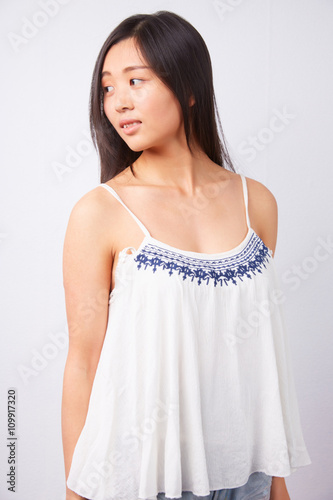 smiling Chinese woman in a white top