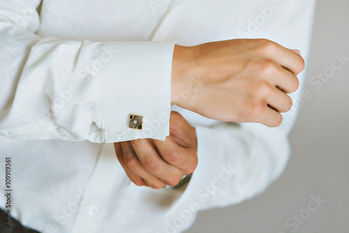 close up of a hand man how wears white shirt and cufflink
