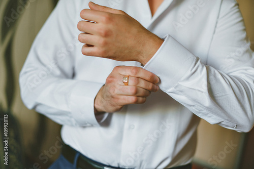 close up of a hand man how wears white shirt and cufflink
