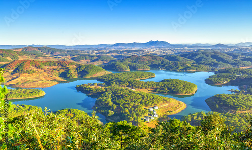 Da lat plateau with yellow sunshine early, lake, winding hill as reservoirs for the city Da lat, Lam Dong, Vietnam